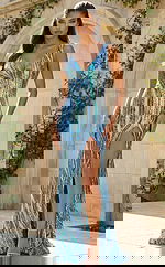 Front view of fitted beaded gown with deep V neckline, swirling bead patterns, and thigh high slit