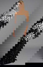 Front view of a strapless black floral brocade column gown