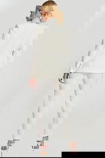 Back view of fitted white suit with structured seams and rhinestone collar