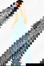 Structured metallic gown with sculpted shoulders, fitted bodice, and layered jacquard leaf pattern design.