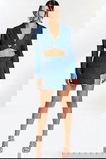 Two-piece denim set with cropped blazer and asymmetrical wrap mini skirt