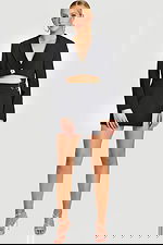 Model Wearing Black Cropped Blazer and Wrap Mini Skirt with Side Cutout