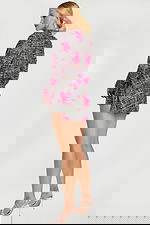 Back view of pink floral tweed cropped jacket and high-waisted mini skirt