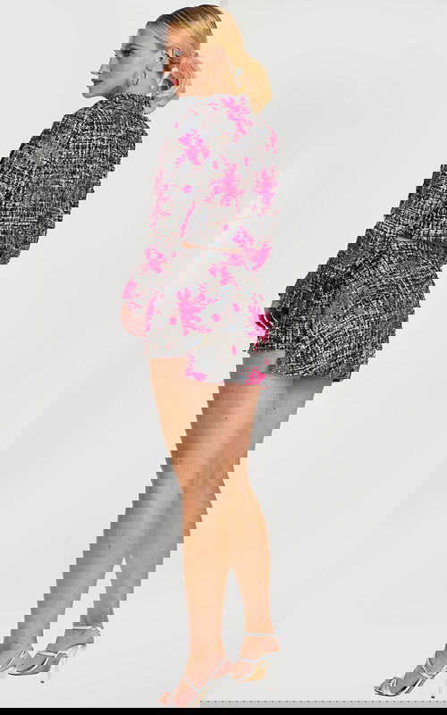 Back view of pink floral tweed cropped jacket and high-waisted mini skirt