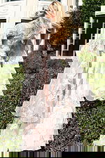 Elegant embroidered gown with light fabric and dramatic flare sleeves