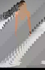 Floor length gown with clean silhouette and flowing hemline