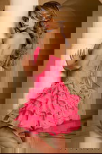 Back detail of a strapless dress with lace‑up closure and multiple flouncy skirt layers