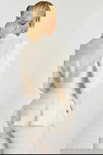 Back view of off-white blazer with fitted waist and soft flared hem