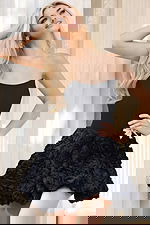 Model wearing black corset dress with structured top and floral skirt