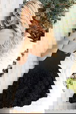 Elegant black dress featuring textured floral skirt and fitted bodice