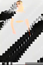 Elegant wide-leg black jumpsuit with embellished neckline and side panels