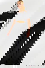 Black pantsuit with short sleeves, jeweled neckline, and front cutout