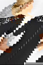 Close-up of rhinestone diamond buttons on white tailored jacket