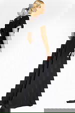 Back view of black jumpsuit showing zipper closure and flared legs