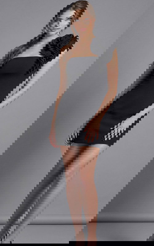 Front view of a fitted one shoulder mini dress with sculpted floral accent