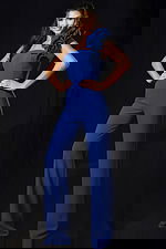 One shoulder blue jumpsuit with ruffle detail and fitted bodice