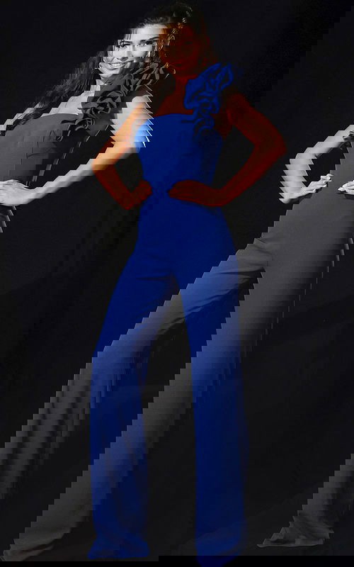 One shoulder blue jumpsuit with ruffle detail and fitted bodice