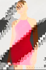 Model facing forward wearing a sleek red halter dress