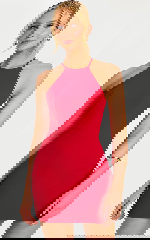 Model facing forward wearing a sleek red halter dress