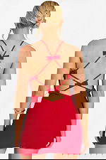 Back view of red mini dress featuring crisscross straps and small bows