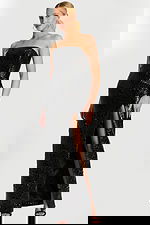 glossy embossed black dress with floral texture and high front slit.