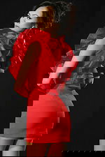 Back view of red ruffled mini dress highlighting bold structured design