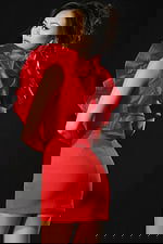 Back view of red ruffled mini dress highlighting bold structured design