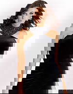 Black velvet gown with a high beaded neckline, sleeveless fitted bodice, and thigh-high slit creating a sleek and sophisticated silhouette.