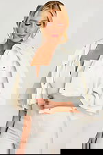 Close-up of bridal white jumpsuit and cape collar with zipper detail