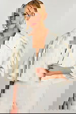 Side close-up showing V-notch neckline and metal zip of bridal cape