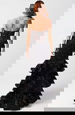 Back view of fitted lace gown with layered ruffles and structured silhouette