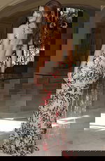 Elegant open back gown with detailed beading and floor length design