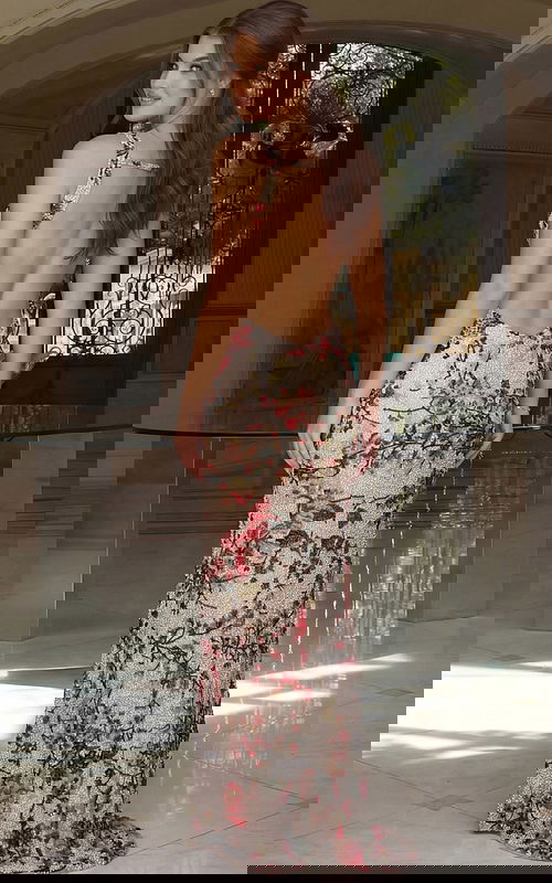 Elegant open back gown with detailed beading and floor length design