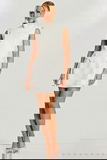 Front view of ivory mini dress with high neck and asymmetrical buttons