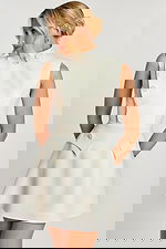 Side angle of sleeveless ivory dress with flared skirt and flap pockets