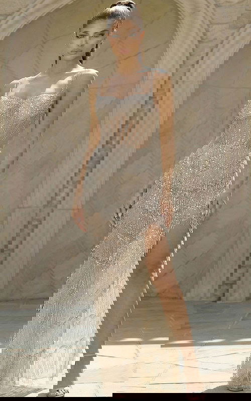 Beaded fringe gown with sheer corset bodice and fitted silhouette