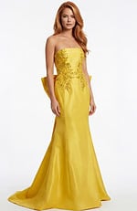 Column gown with oversized bow detail and open back design