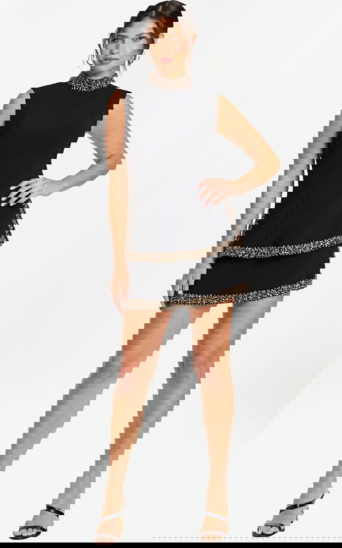 Sleeveless black mini dress with beaded high neckline and layered skirt