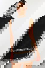 Close-up of black embellished mini dress with high neckline detail