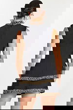 Back view of black mini dress with tiered skirt and beaded trim