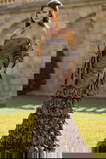 Strapless fitted gown with textured fabric and layered ruffle skirt