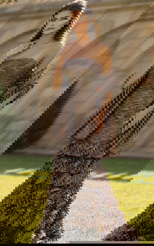 Strapless fitted gown with textured fabric and layered ruffle skirt