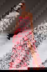 Strapless floral gown with a structured corset bodice, tiered ruffle skirt, and a thigh high slit creating a romantic, flowing silhouette