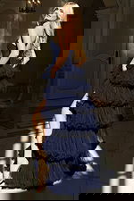 Elegant ball gown featuring sheer corset bodice and voluminous tiered skirt