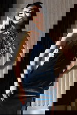 Blue embellished gown with open back and thigh-high slit