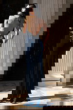 Dark blue formal dress featuring halter neckline and floral beadwork