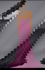 Back view of strapless fitted gown with smooth silhouette and flowing hem