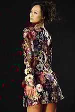 Back view of embroidered floral mini dress with see-through sleeves