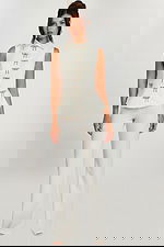 Front view of sleeveless ivory pant suit with rhinestone bow detailing