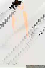 Back view of sleeveless ivory peplum top and wide-leg pants